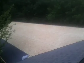 New OSB roof sheathing installed beside an existing shingle roof in Cedar City